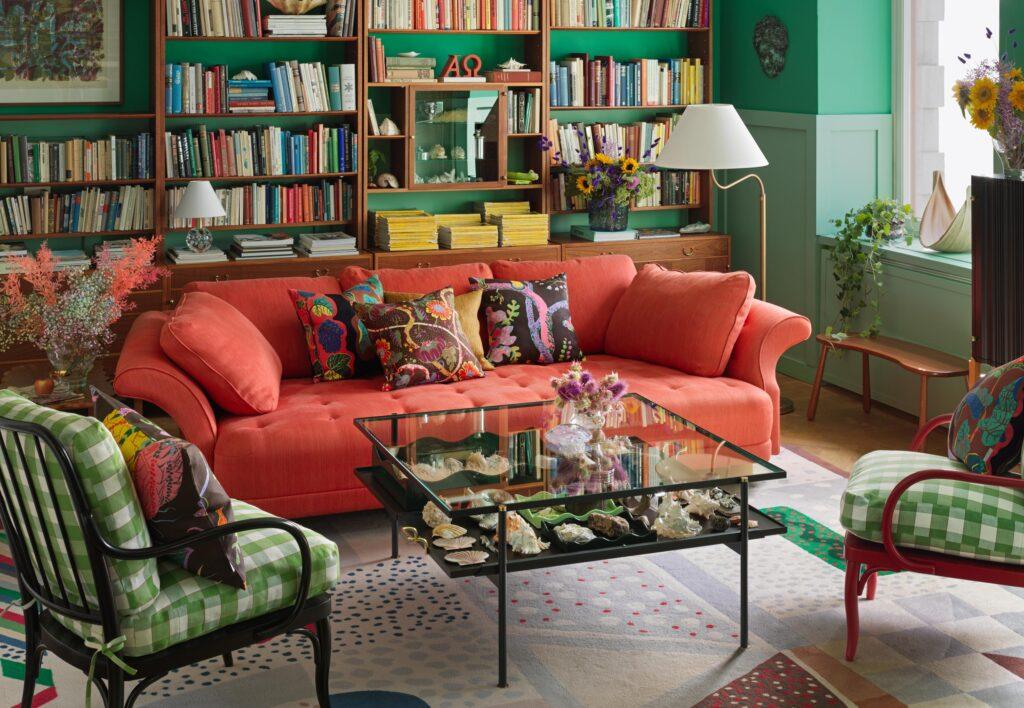 A colourful living room with an orange sofa.